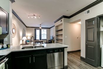 the view of a kitchen and living room from the counter top of a counter top